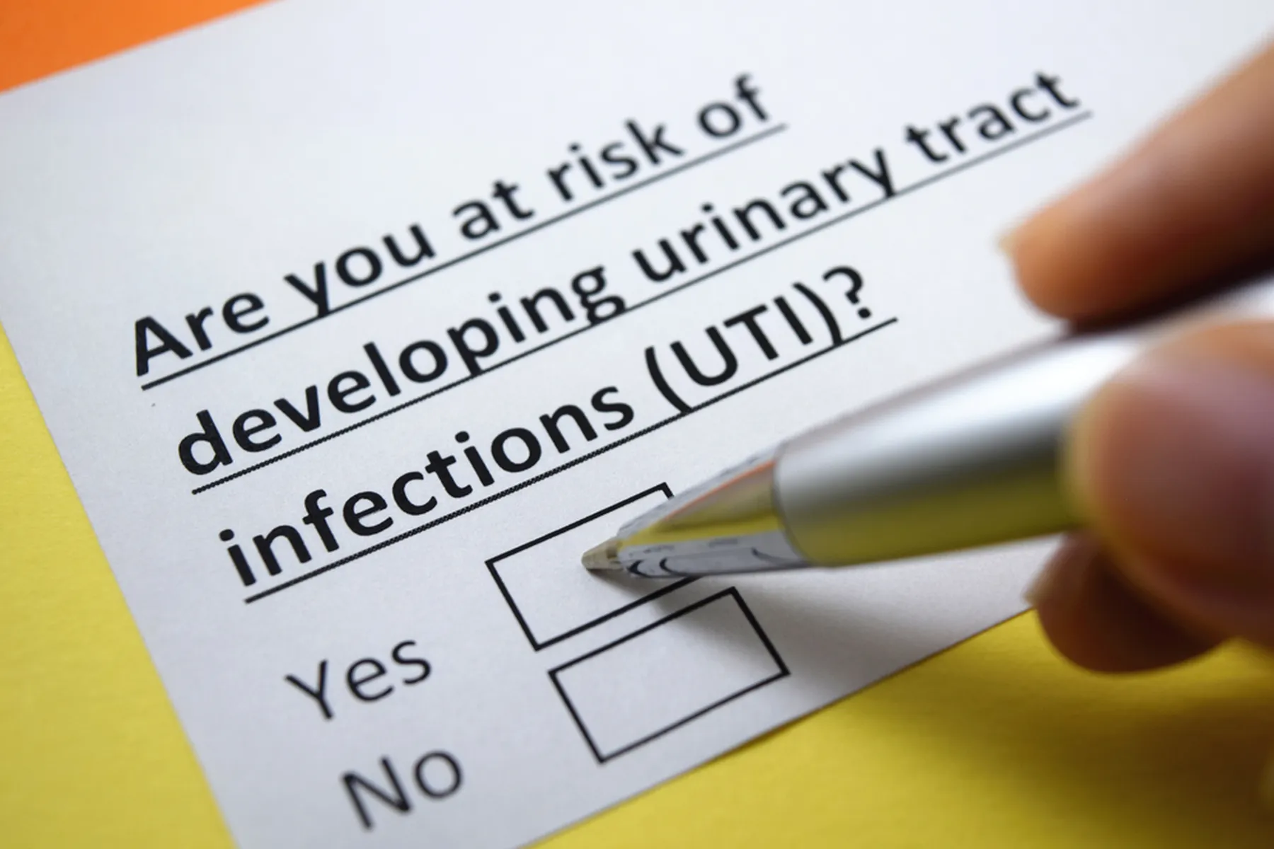 At risk of UTIs, check yes or no, with pen pointing to yes.
