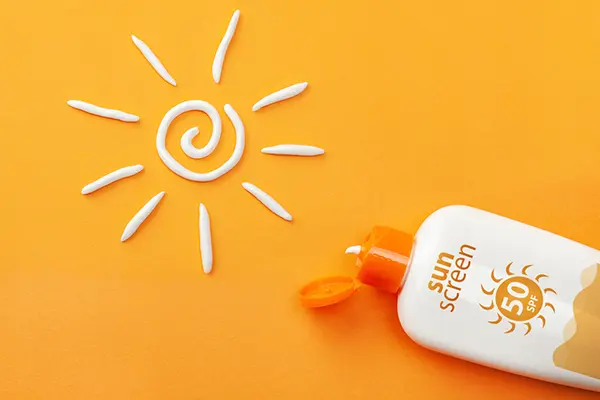 Sunscreen bottle next to a sun drawn with sunscreen.