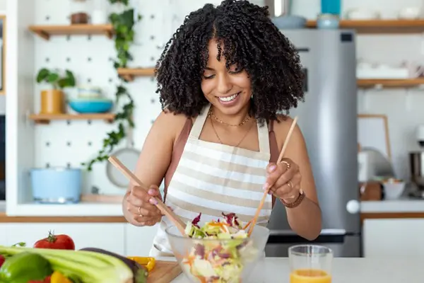 Woman making herself a healthy salad.