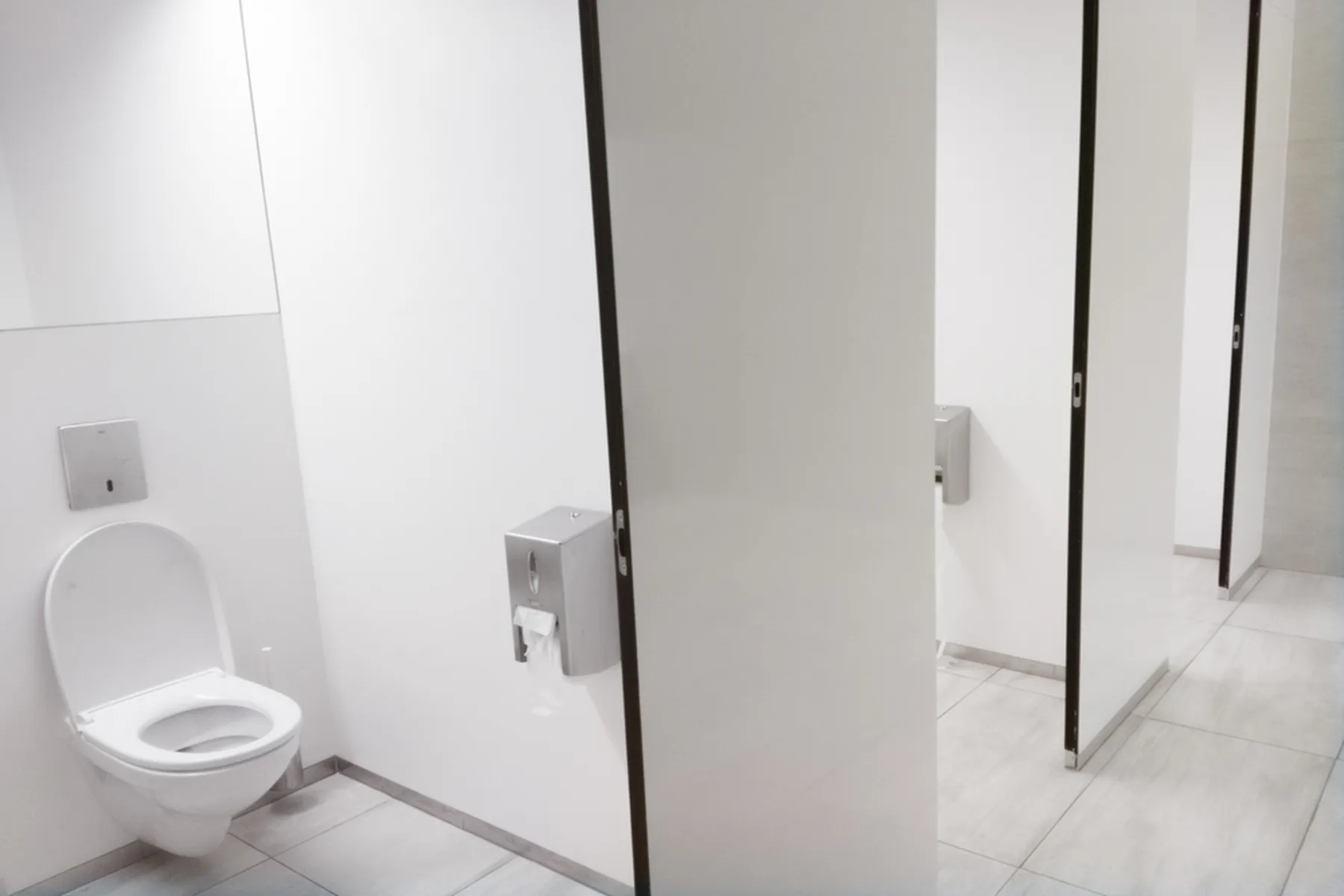 A white bathroom stall with a toilet.