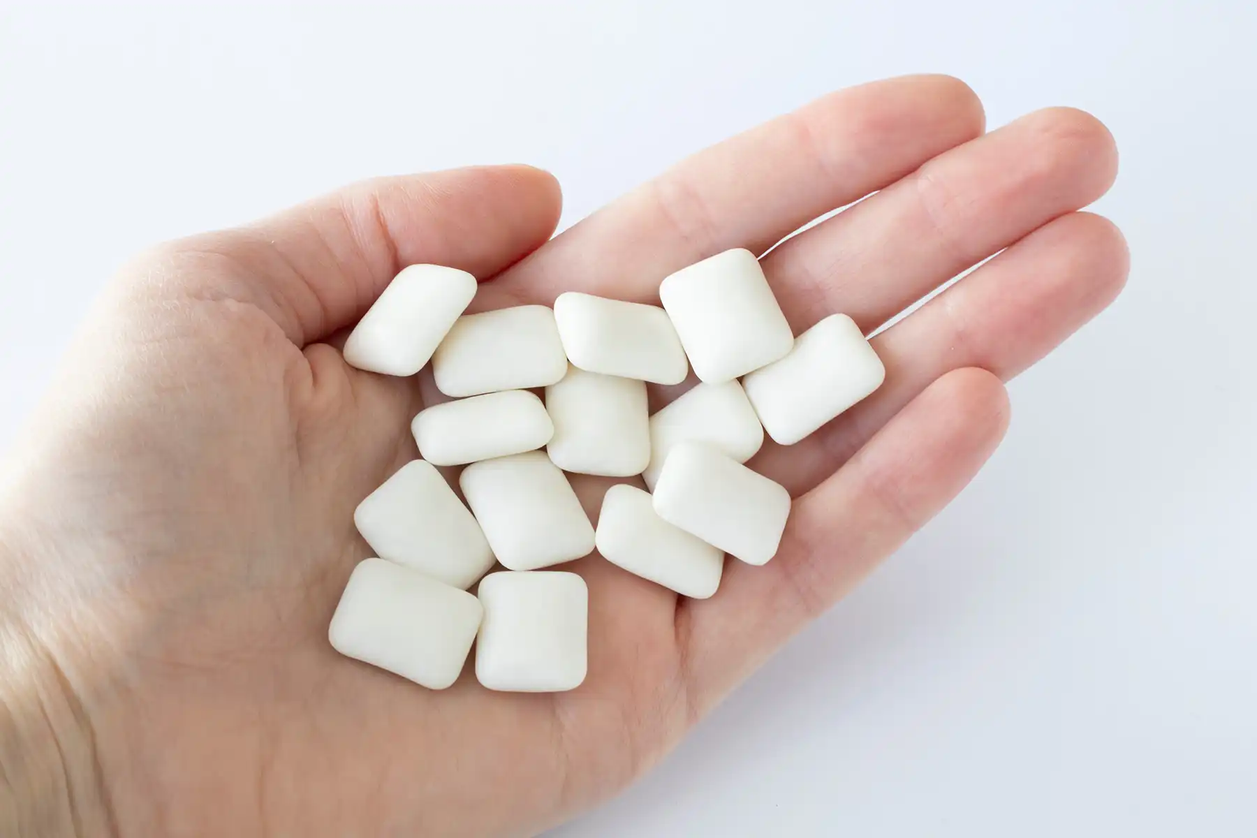 Chewing gum tablets (with xylitol as a sweetener( in someone's hand.