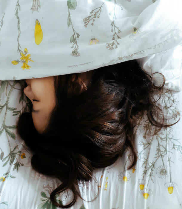 womans-head-appears-from-sheets womans-head-appears-from-sheets