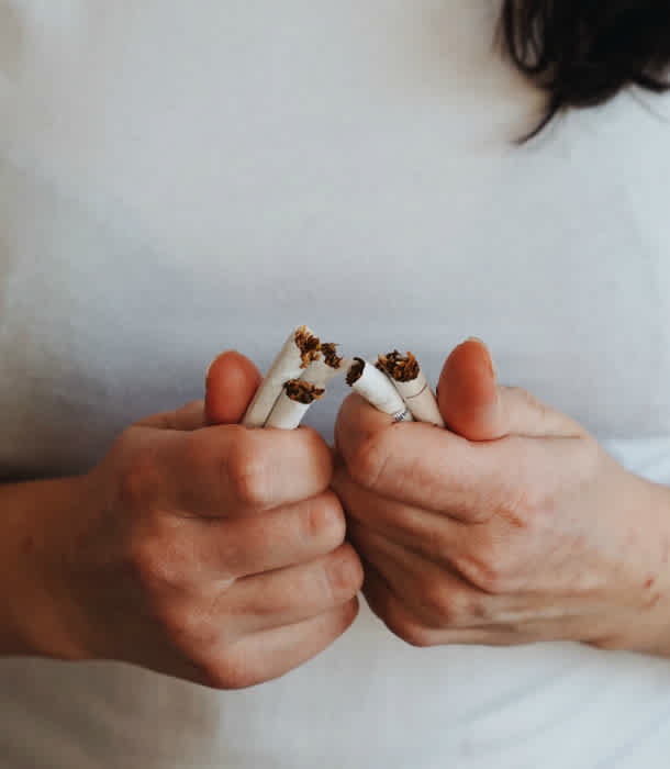 woman-breaks-cigarettes-in-half woman-breaks-cigarettes-in-half