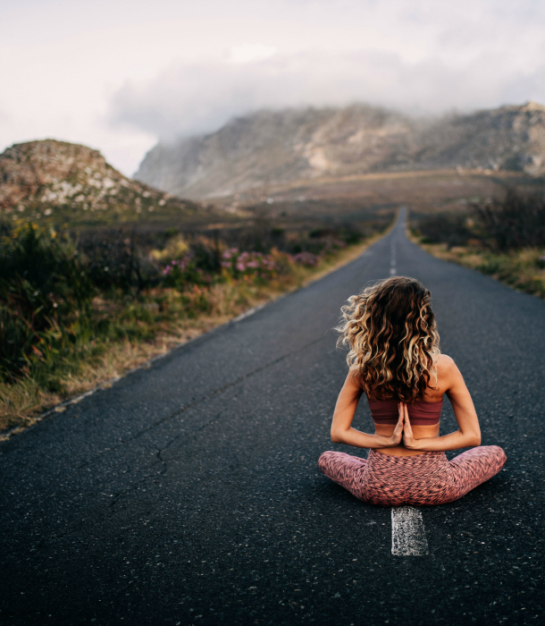 woman-meditates-in-middle-of-road