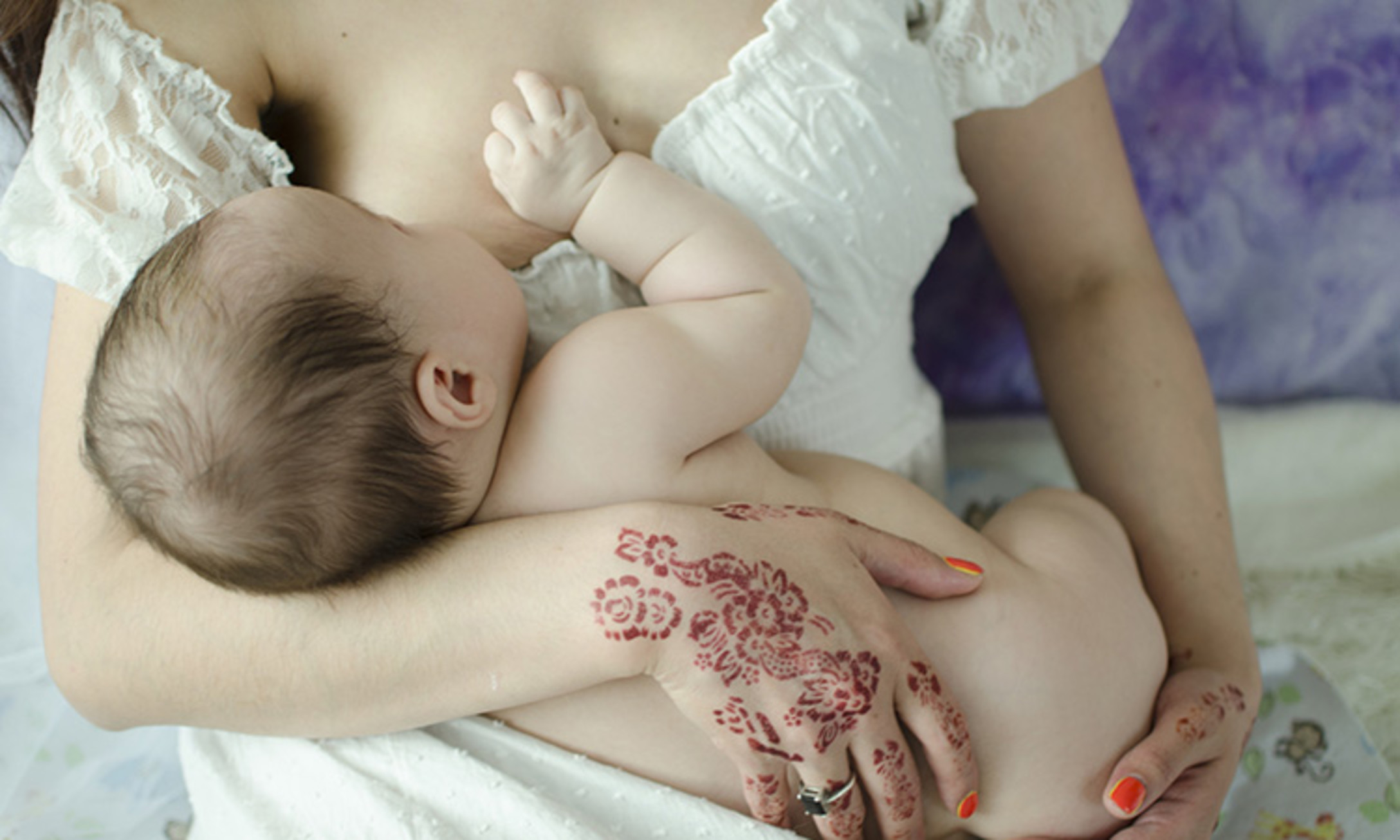 beautiful mom feeding baby