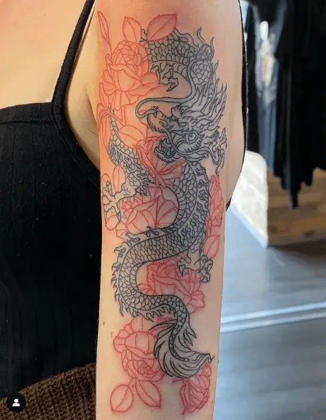 Blackline of a Chinese dragon with red outlined lotus flowers in the background-min