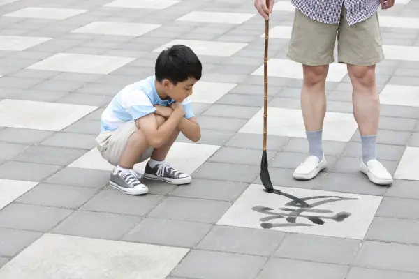 writing calligraphy on the ground
