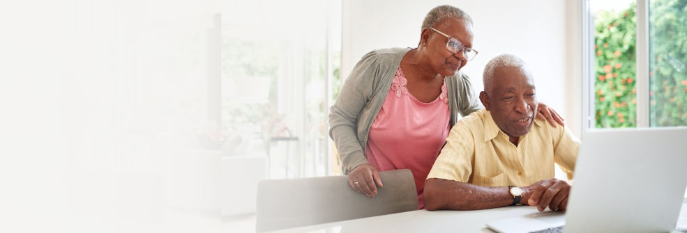 LivingWell Companion, Managing your account, header image showing senior citizens looking at a laptop screen.