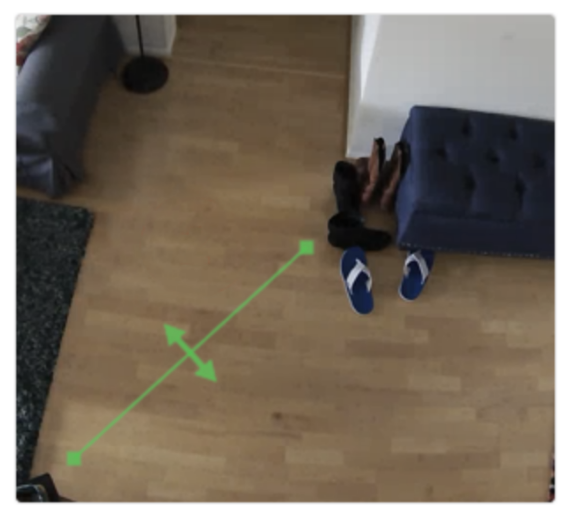 An indoor camera screenshot of a living room and a select area highlighted in green to show the shape of the ground zone.