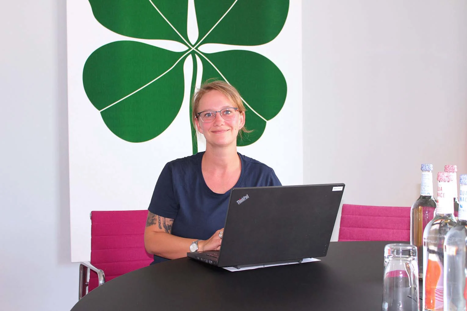 Operations Coordinator Laura am Standort Heidelberg Colours am Laptop