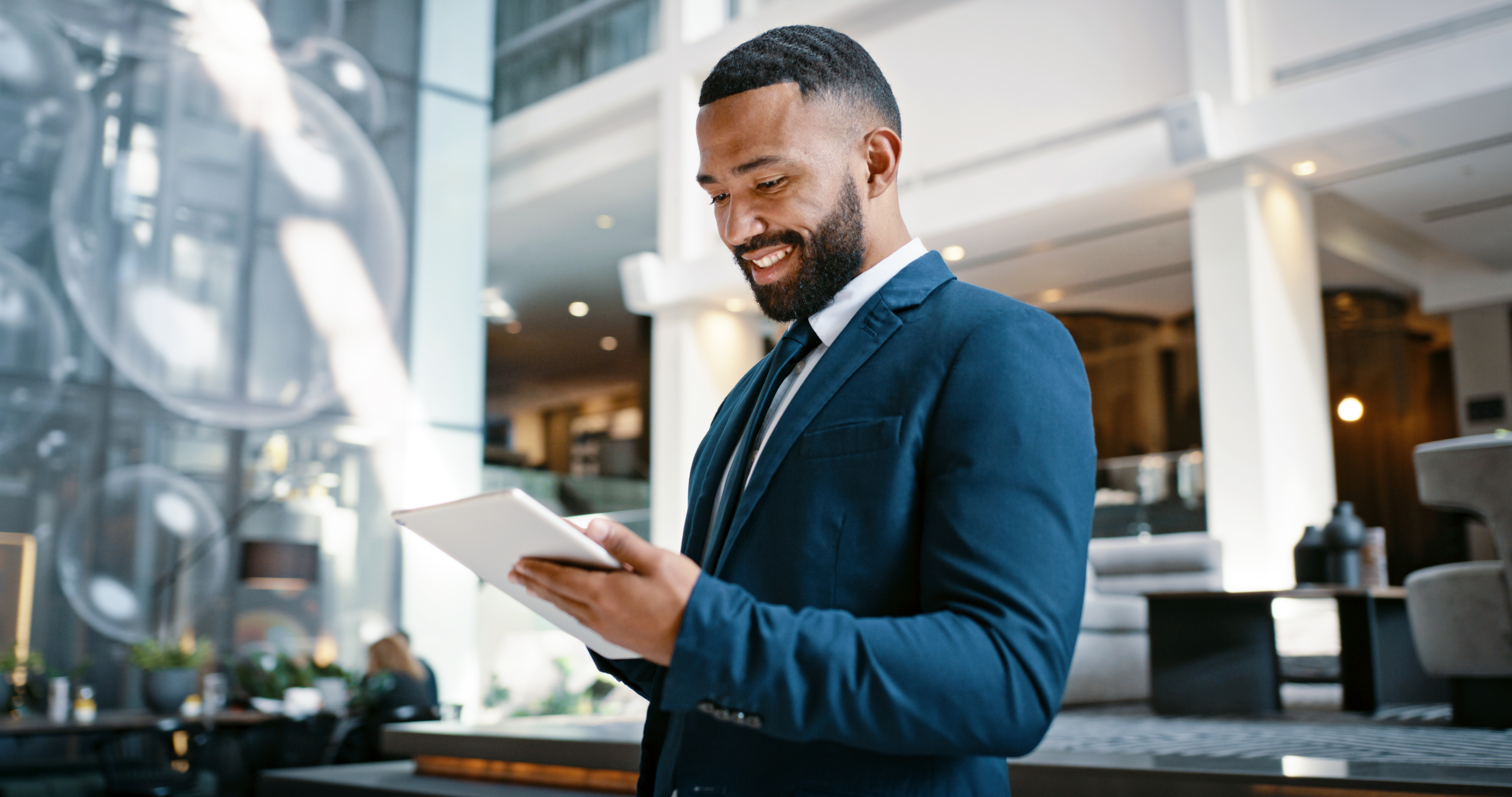 Man at a hotel with a tablet.