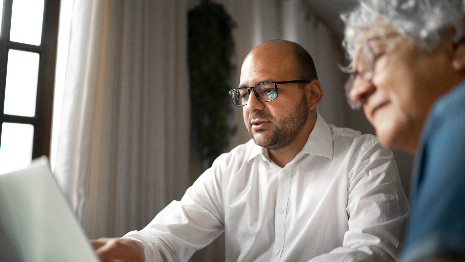 Man and woman looking at a laptop screen 