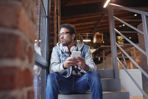 Young creative man waits by the phone - DocuSign