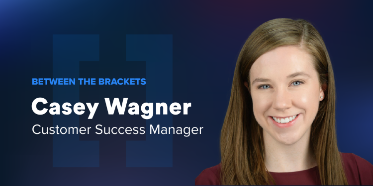 A headshot of Customer Success Manager Casey Wagner on a dark blue background.