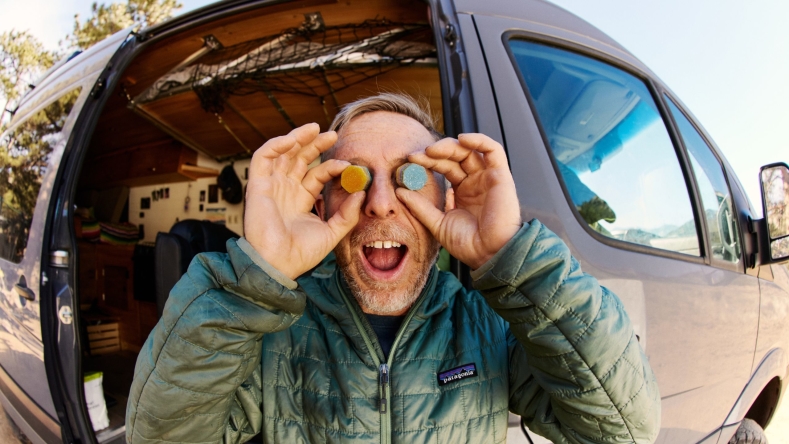 Tommy Caldwell holding gummies next to his eyes