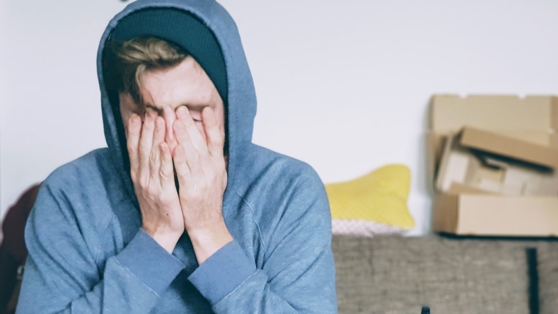 Stressed man with blue sweatshirt 