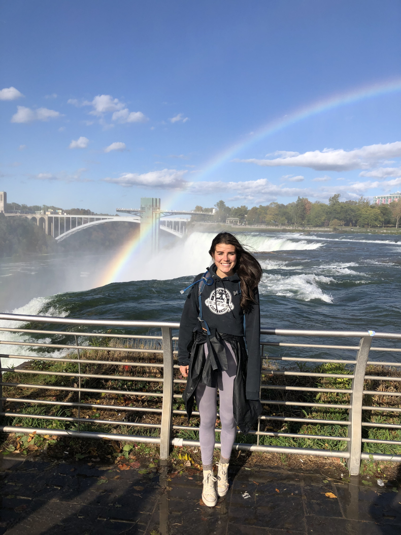 Alayna Hutchinson with rainbow in the background