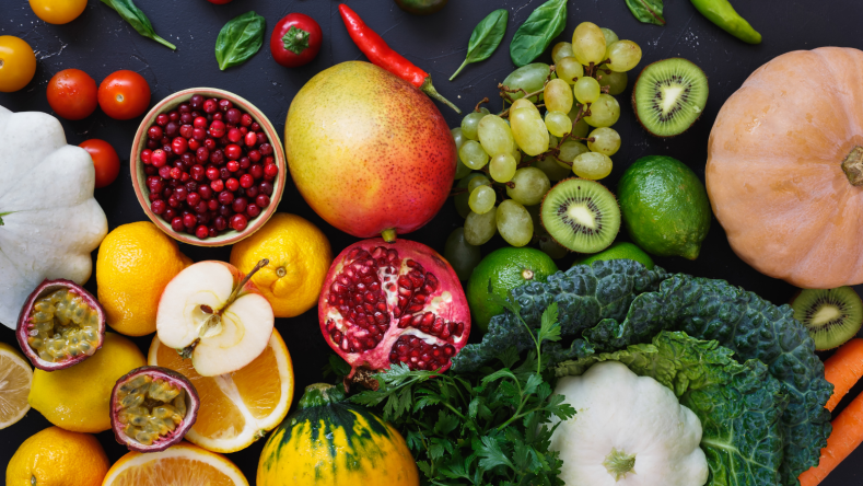 fresh fruit and vegetables on a slate background