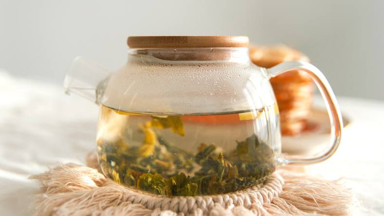 green tea steeping in a glass kettle