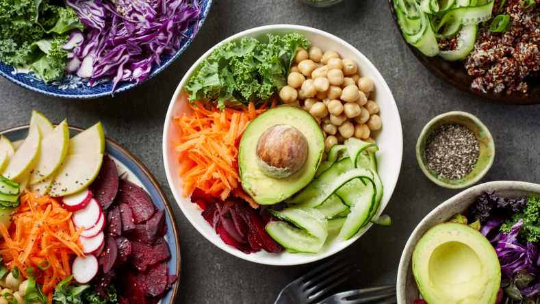 vegan bowl with avocado, chickpeas, lettuce, and carrots