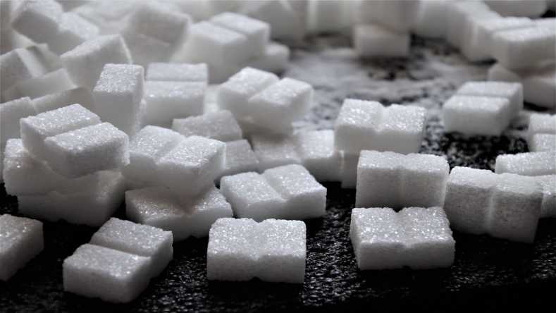 sugar cubes stacked on dark surface