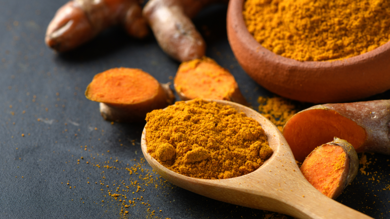 Ground turmeric in a spoon