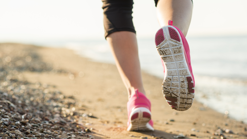 woman running with pink shoes