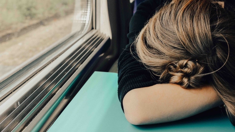 person sleeping on train