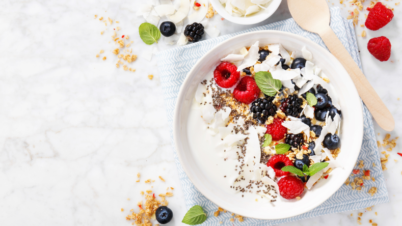 yogurt bowl topped with fruit and chia seeds