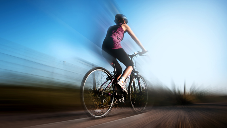 Blurred photo of a female cyclist on a bike