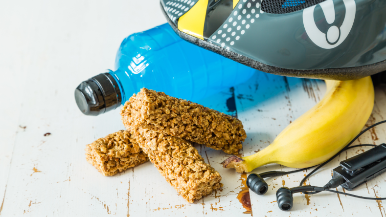 energy bar and banana next to cycling helmet