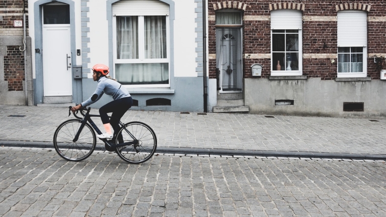 woman with orange helmet cycling