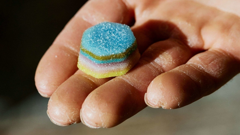 Tommy Caldwell holding gummy in palm of hand