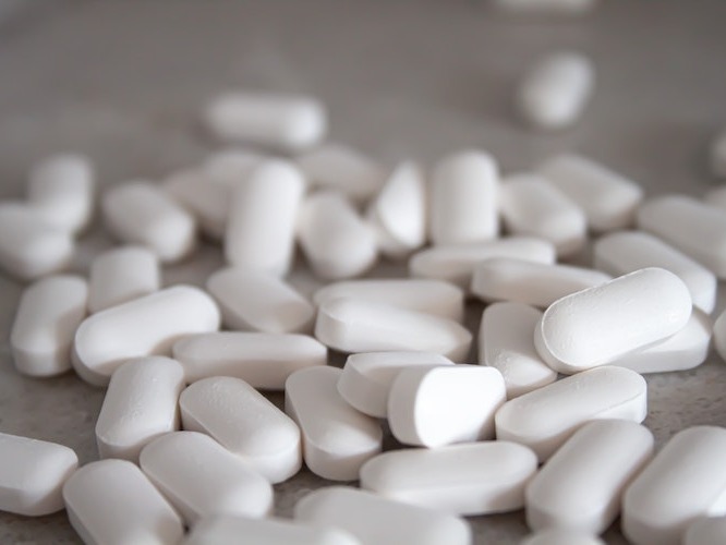 Glucosamine pills on a gray background