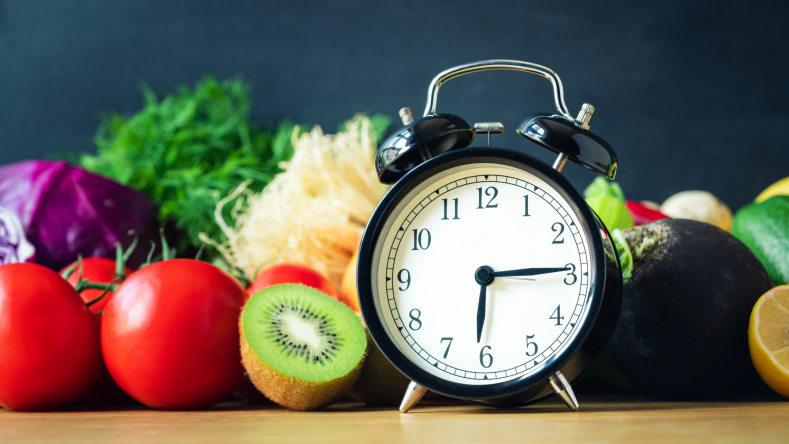 clock with fruit and vegetables in the background