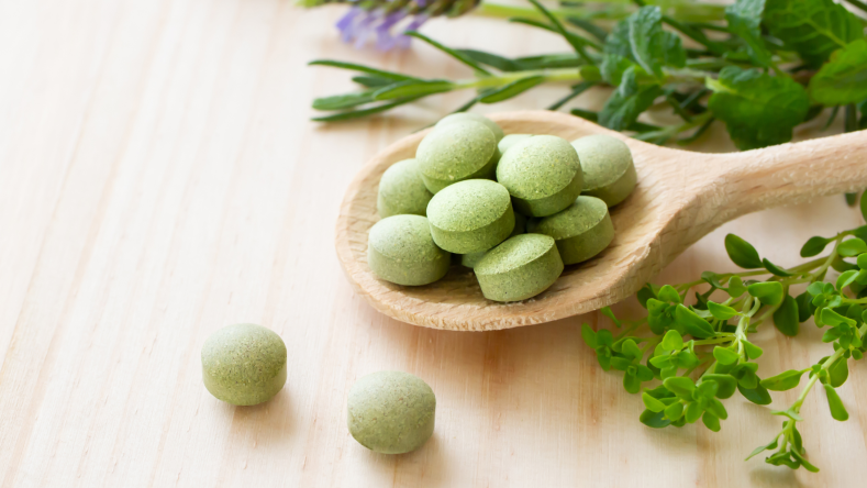 Supplements in a wooden spoon