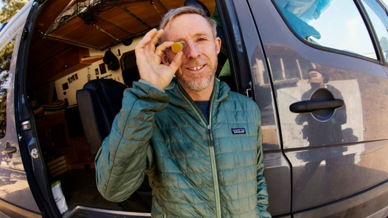 Tommy Caldwell holding one gummy to his face