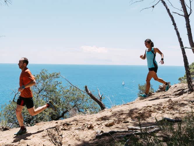 Strava - two people running on trail overlooking the ocean