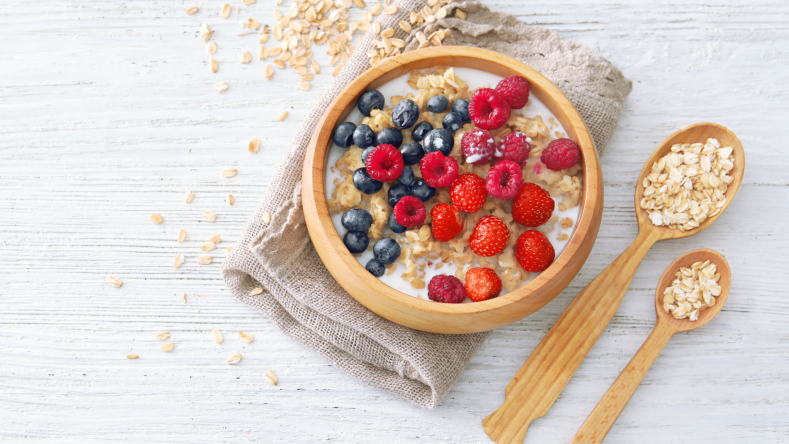 Oatmeal with berries in a wooden bowl