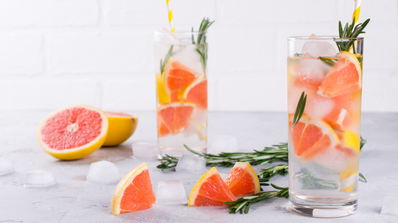 water glasses filled with grapefruit slices and rosemary