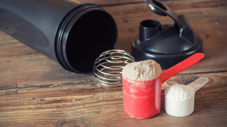 protein powder in a red scoop