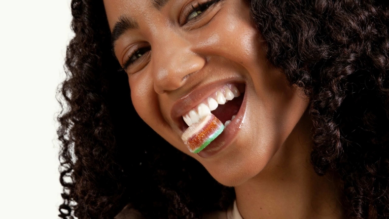 woman holding smart gummies in her mouth