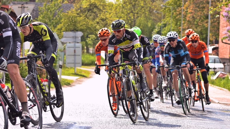 group of people cycling along road