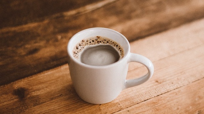 Coffee in a white mug on a wooden table