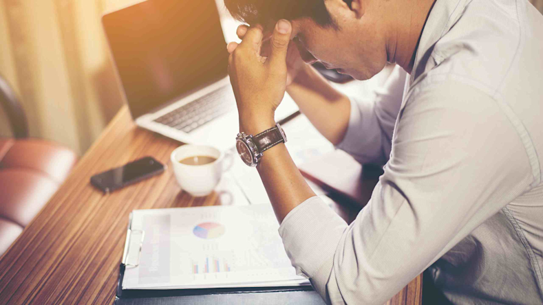 stressed out man sitting at desk