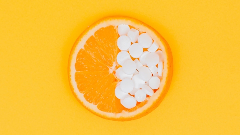 orange slice half filled with white pills