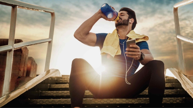 man drinking a pre workout shake