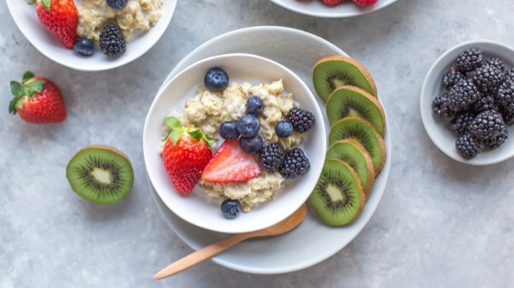 Bowl of oatmeal with strawberries, blueberries, blackberries and kiwi