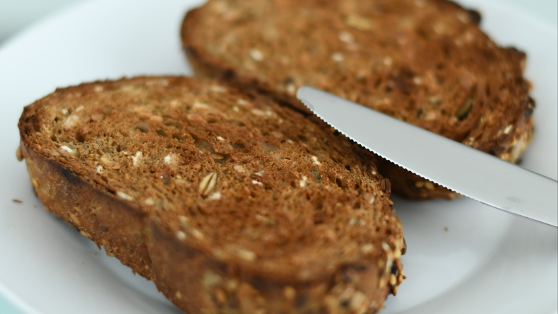 Multi-grain toast on a white plate
