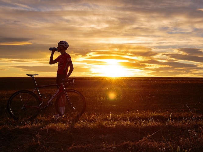 Cyclist hydrating during morning ride